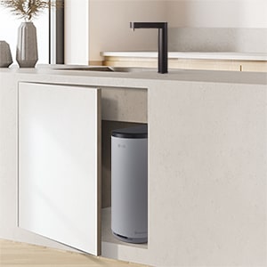 A water purifier partially visible through a slightly open under-sink cabinet	