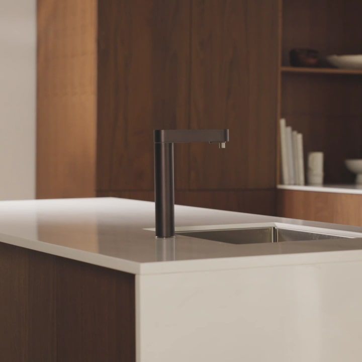 A video closing the under-sink cabinet containing the purifier and dispensing water from the faucet	