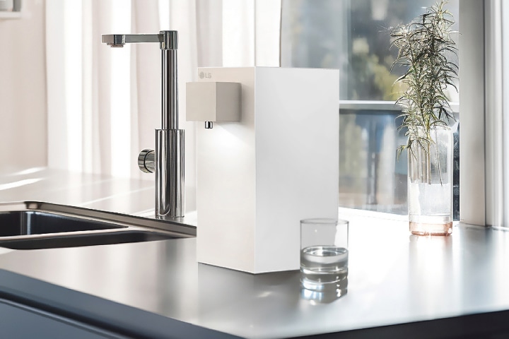 LG water purifier with purewhite light on in a bright kitchen.
