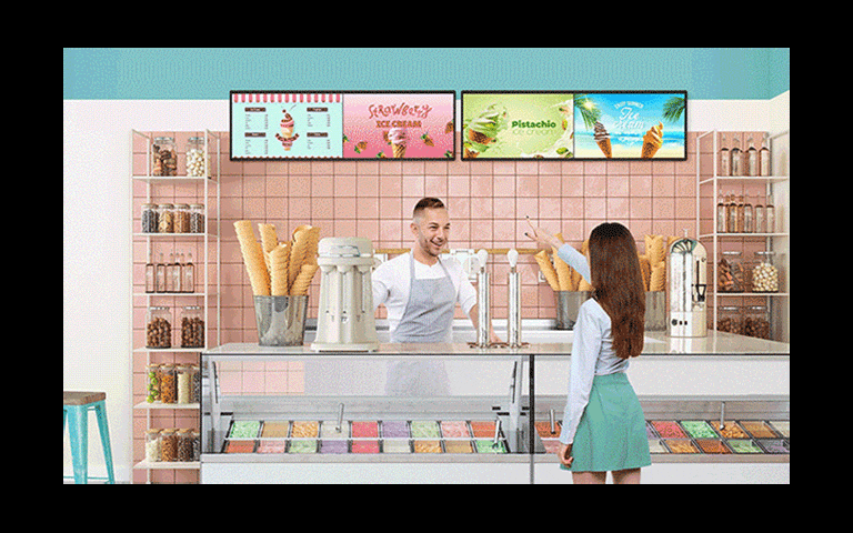 Inside an ice cream shop, there is a BH7N installed, and the screen is simultaneously showing the ice cream menu and advertisements.