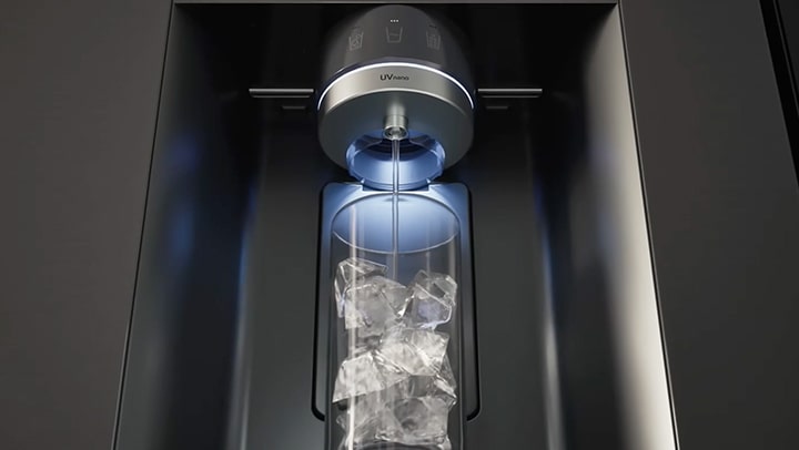 Water being dispensed from a dispenser nozzle with the UVnano feature into a cup filled with ice.