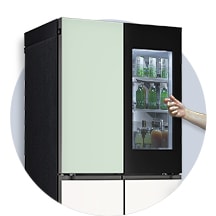 The front view of a black InstaView refrigerator with the light on inside. Hands tapping on InstaView screen.