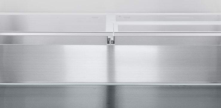 A diagonal view of the shelf with metallic paneling on the interior of the refrigerator.