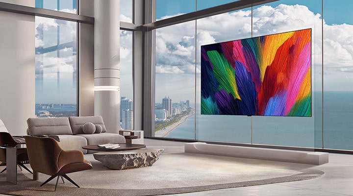 LG OLED evo AI W6 Wallpaper TV with a 9mm-range profile appears flush against a glass-walled high-rise living room, where its vibrant abstract display enhances spatial depth while preserving a clean, balanced interior aesthetic.