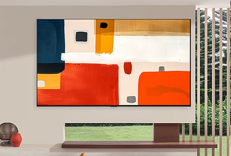 LG OLED evo AI G6 showcases a large, vibrant abstract painting centered on a white wall and elevating the modern interior into a curated gallery-like atmosphere.