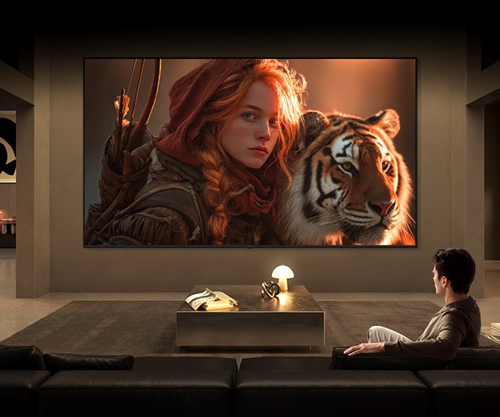 LG TV for watching movies fills a modern living room with a cinematic scene on a large wall-mounted display, featuring a detailed close-up of a character and tiger, highlighting rich color depth, strong contrast, and immersive viewing.