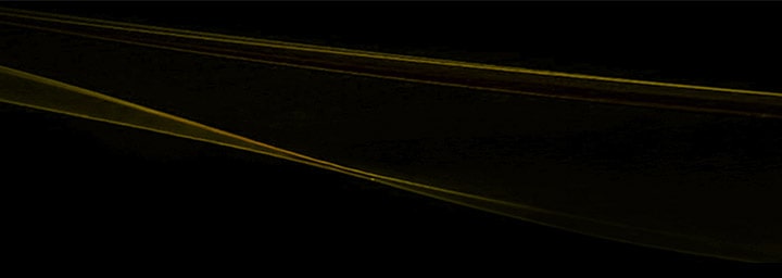 LG TV as a cinema TV is visualized as abstract gold wave-like lines on a black background, extending horizontally with smooth curves and gradient tones to form a continuous flowing pattern.