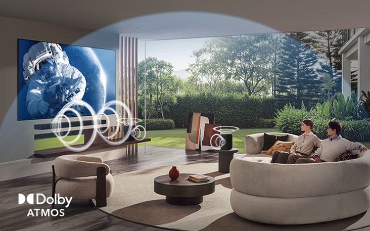 LG TV with Dolby Atmos displays a wide space scene in a living room, with graphic sound waves surrounding viewers and speakers to indicate immersive, multi-directional, object-based audio.