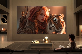LG TV for watching movies fills a modern living room with a cinematic scene on a large wall-mounted display, featuring a detailed close-up of a character and tiger, highlighting rich color depth, strong contrast, and immersive viewing.