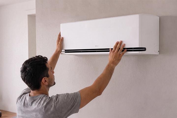 Man opening an LG DUALCOOL AI Air for cleaning