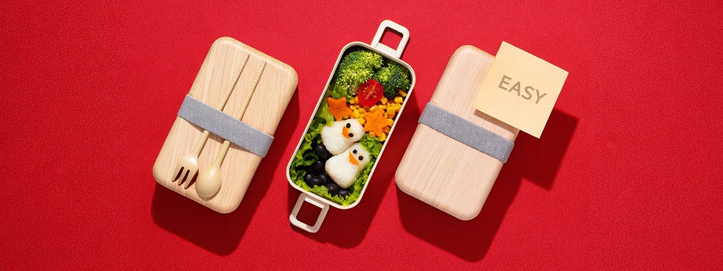 An image showing an easy bento box meal with penguin-shaped rice balls and colorful vegetables on a red background, illustrating a simple meal-prep concept.