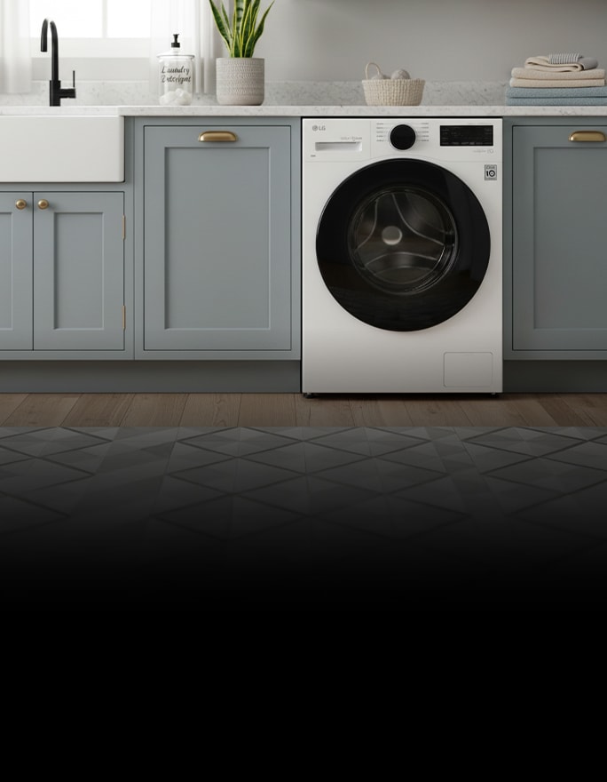A white washer-dryer combo is placed beneath a wooden shelf, surrounded by neatly folded towels, baskets, and small decorative items.