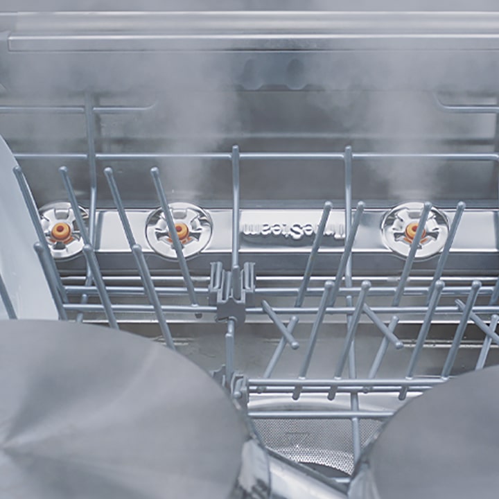 Video of close-up view of various types of dishes with steam being released inside the dishwasher.
