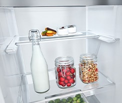 The front of a freezer is shown with blue shape and arrows pointing to demonstrate how the freezer fits in a kitchen space. 