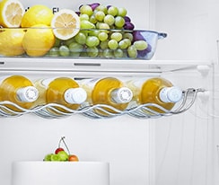 The top of the freezer is shown at an angle with two arrows pointing in toward the wall to indicate it is flush with the cabinets surrounding it.