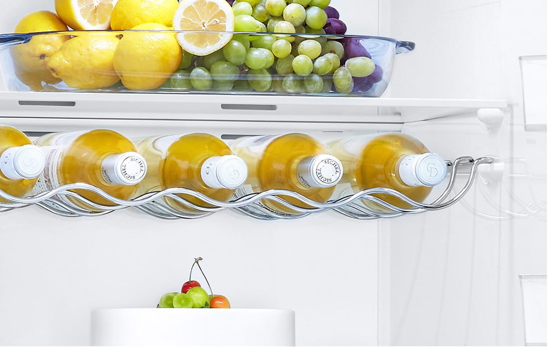 The top of the freezer is shown at an angle with two arrows pointing in toward the wall to indicate it is flush with the cabinets surrounding it.