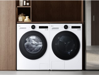 In the laundry room, a silver LG washing machine is placed beside a gray drawer, with detergents stored on top of the drawer.
