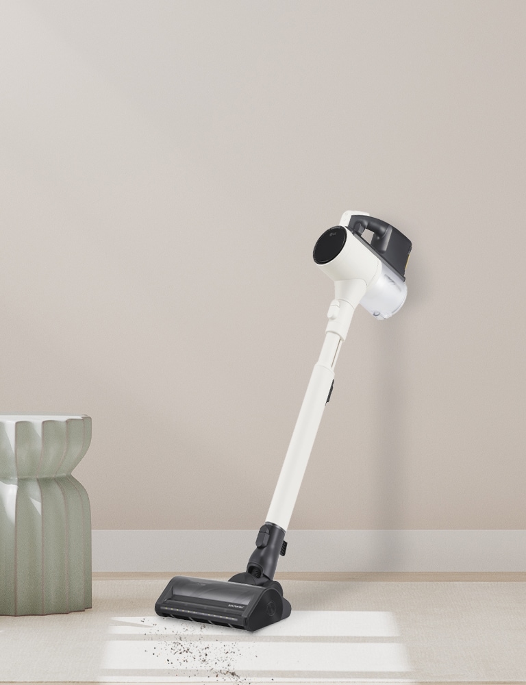 Stick vacuum leaning against the wall.