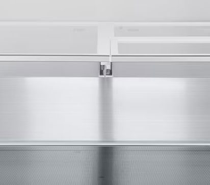 A diagonal view of the shelf with metallic paneling on the interior of the refrigerator.