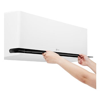 Hands opening the lower vane of an LG air conditioner for cleaning or maintenance