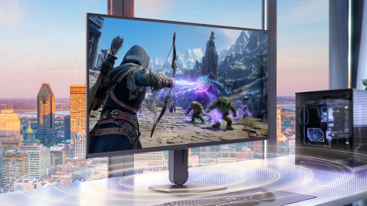UltraGear™ gaming monitor on a desk setup with a desktop PC, displaying a fantasy action game scene and highlighting an immersive gaming environment with built-in stereo speakers for clear audio during gameplay.