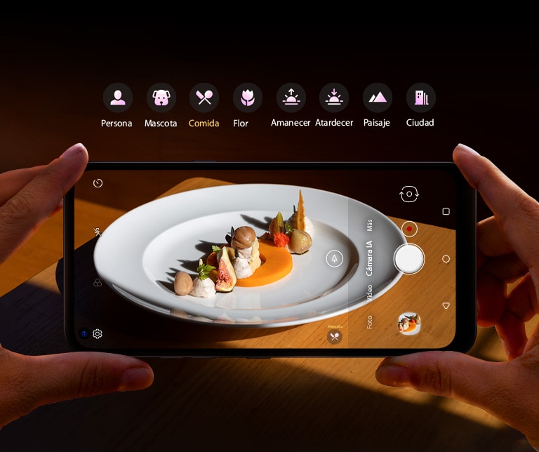 Primer plano de alguien que sostiene un teléfono inteligente que le saca fotos a la comida