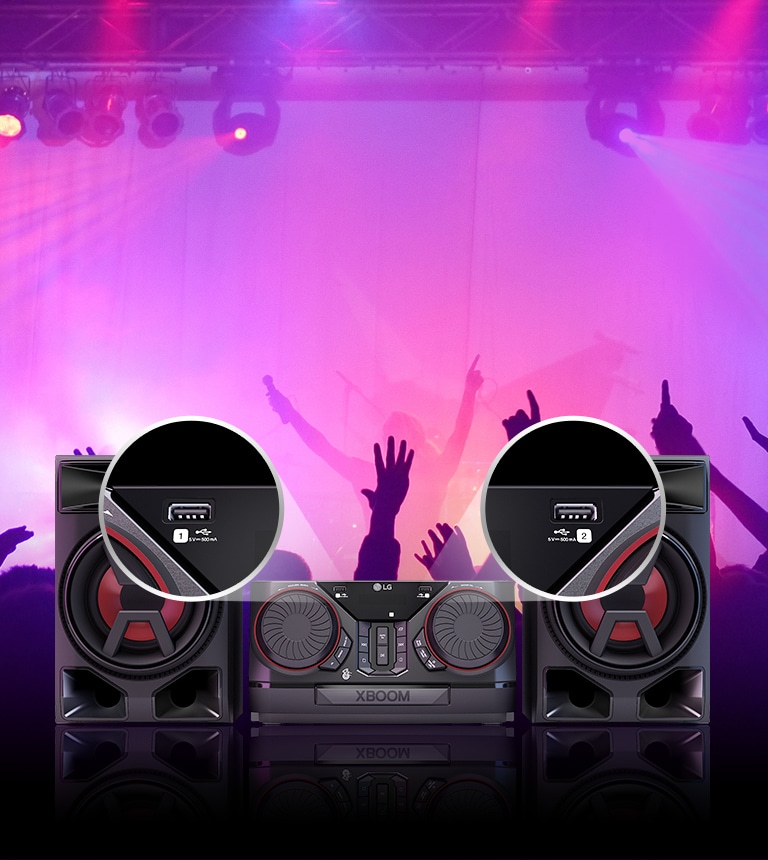 Front view of the LG XBOOM CK43N. The two USB ports are shown zoomed in. Behind the product, silhouettes of partygoers are visible.