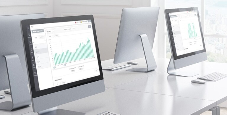 LG HVAC Central Controller interface is displayed in a modern office setting with computers, focusing on energy navigation.