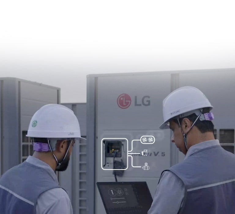 Technicians using a laptop to service LG MULTI V HVAC equipment, showing smart diagnostic interface during maintenance work.	