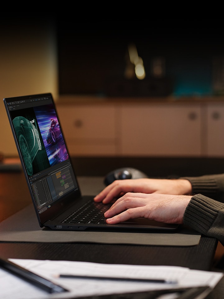 An individual is sitting at a desk, editing a video on their laptop.