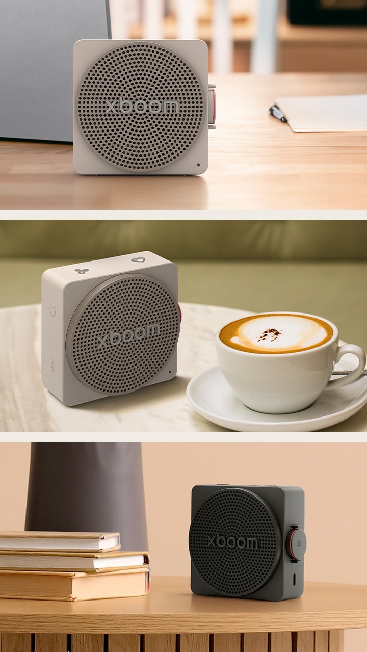1) LG xboom mini grey-colored, placed on a desk next to a laptop, showing a compact bluetooth speaker with a lifestyle-fit design for indoor 2) LG xboom mini grey-colored on a coffee table, a compact bluetooth speaker with space-filling sound for both indoor and outdoor use 3) LG xboom mini black-colored placed among books and objects, a small bluetooth speaker designed for convenient everyday use