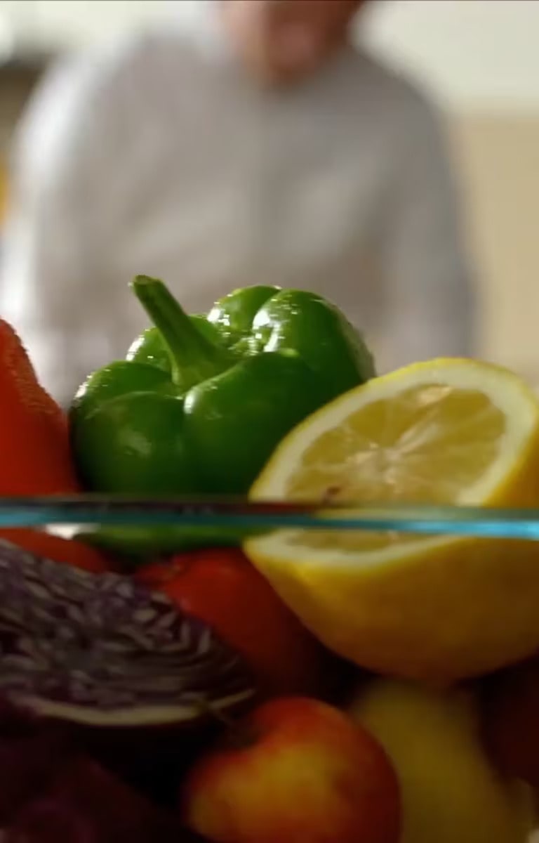 The chef is trimming the ingredients.