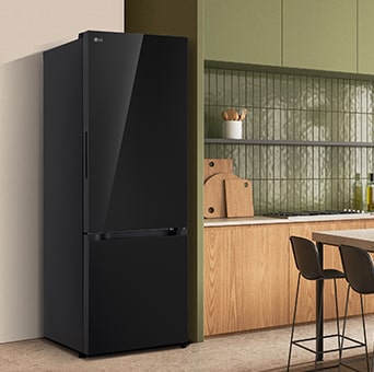 A modern lg black bottom freezer refrigerator with water dispenser is seamlessly fit next to a wooden kitchen countertop.