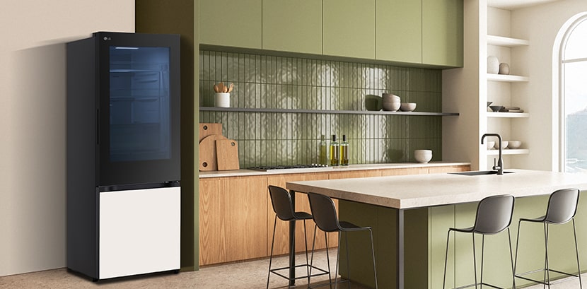 The side view of lg bottom freezer refrigerator with instaview with green cabinets and a stylish island.	