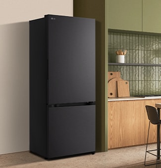 A modern lg black bottom freezer refrigerator with water dispenser is seamlessly fit next to a wooden kitchen countertop.