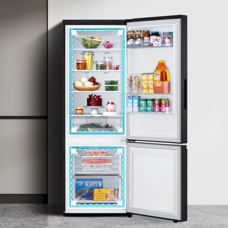A lg bottom freezer refrigerator with increased in total volume and neatly organized shelves filled with various foods and beverages.