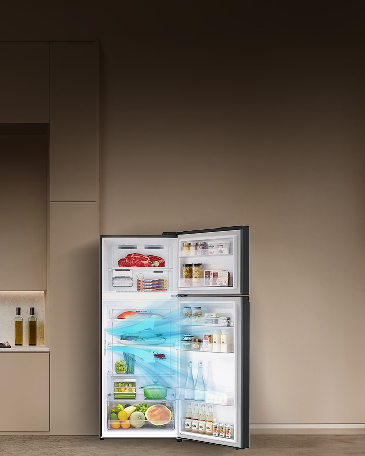 Modern kitchen interiror with a large open lg top freezer refrigerator stocked with various food item explaining how the door cooling feature works.