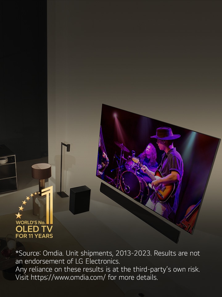 An aerial view of a man and woman watching a concert on a large OLED TV in a modern apartment. The "World's No. 1 OLED TV for 11 Years" emblem is in the image. A disclaimer reads: "Source: Omdia. Unit shipments, 2013-2023. Results are not an endorsement of LG Electronics. Any reliance on these results is at the third-party’s own risk. Visit https://www.omdia.com/ for more details."