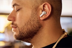 A man is listening music with LG TONE Free