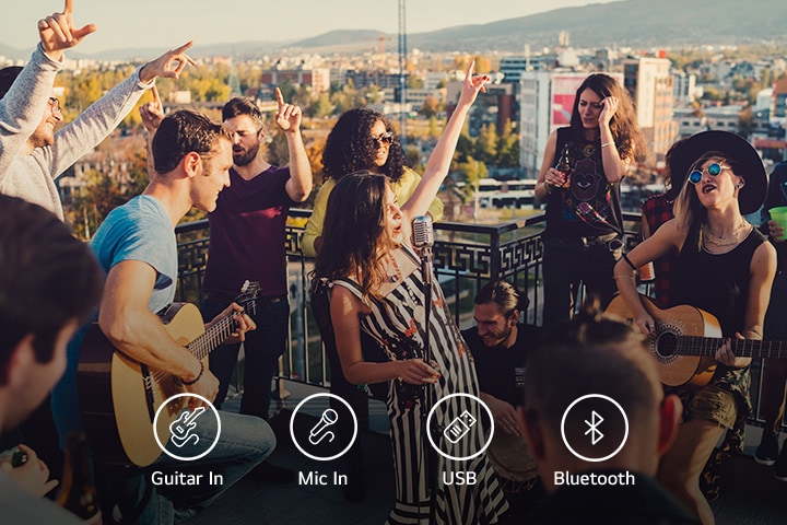There are people enjoying acoustic concert with LG XBOOM XL5S. Below the image, there are guitar 