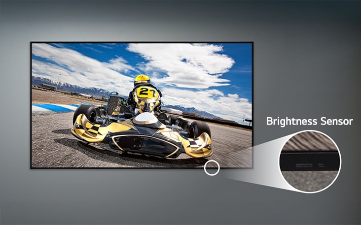 A UL3Q is mounted on the wall, with a close-up of the brightness sensor located on the lower front of the display.