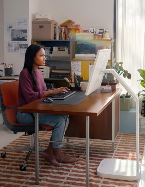 Kobieta siedząca przed inteligentnym monitorem