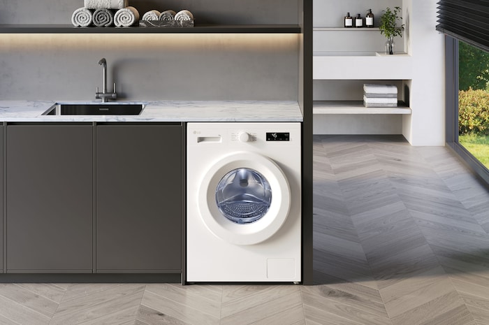 Pralka LG F4X1008NWH 8kg w kolorze Essence White, zainstalowana pod blatem w nowoczesnej pralni.
