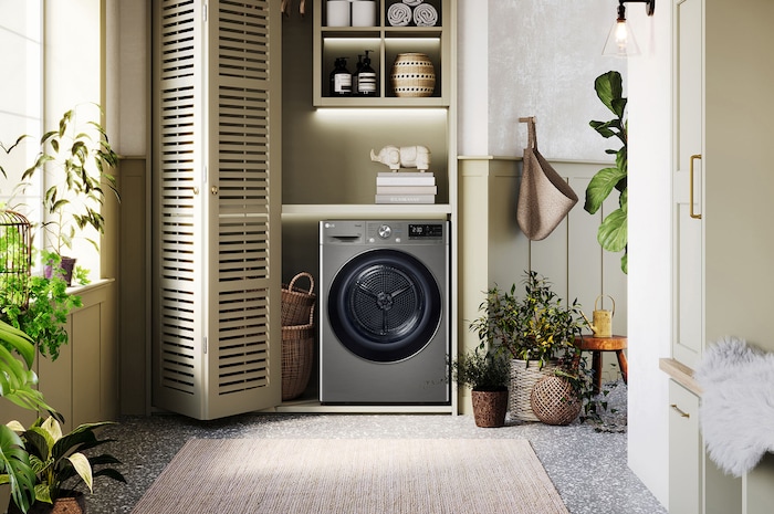 Biała suszarka 10 kg LG RC10V9PV2W zainstalowana w nowoczesnej pralni z szafami żaluzjowymi.