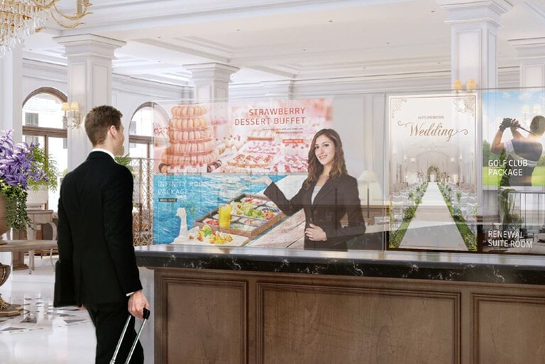 Na przezroczystych ekranach OLED mężczyznaowi pokazywane są informacje i zdjęcia z menu deserów.