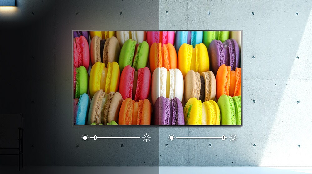 Um ecrã, metade às escuras, metade sob luz, a mostrar uma imagem de macarons coloridos. O brilho é ajustado de cada lado.