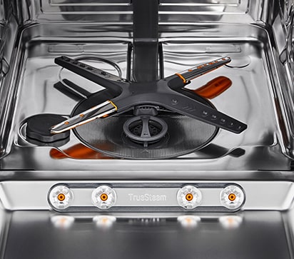 Interior da cozinha com uma máquina de lavar loiça de encastre entreaberta que ilustra o funcionamento da porta fixe e deslizante.