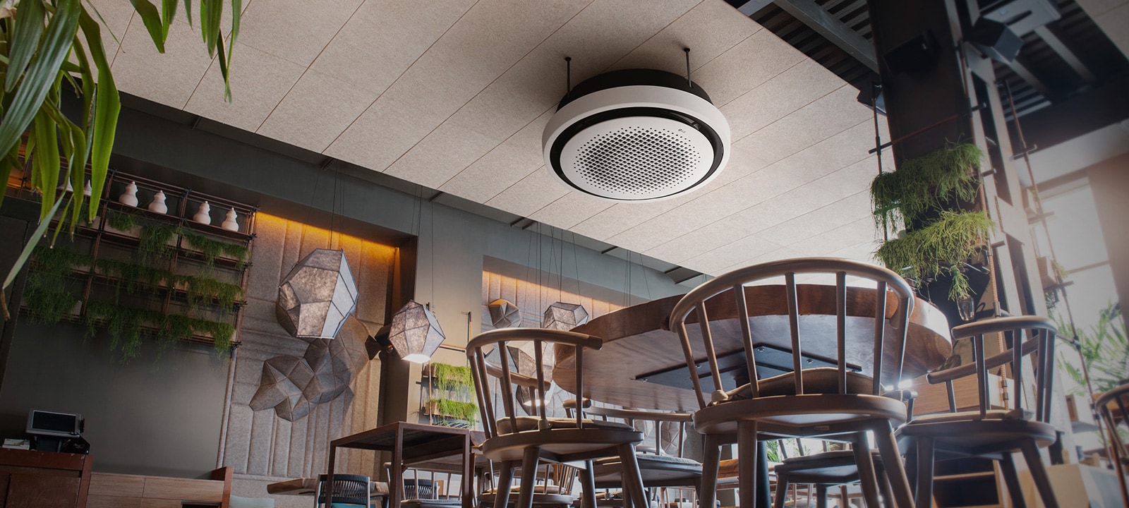 From an ant's perspective, a café unfolds, adorned with chairs, tables, and plants, while an LG round cassette is displayed at the ceiling.	