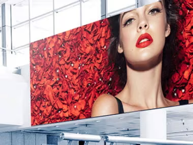 Digital signage showing a woman surrounded by flower petals