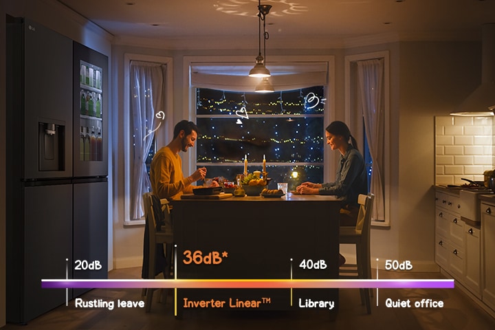 A couple is enjoying a meal in front of a quiet refrigerator.